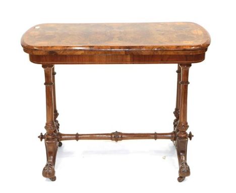 A Victorian Burr Walnut Foldover Card Table, circa 1870, of rounded rectangular form, on four fluted and carved tapering supp