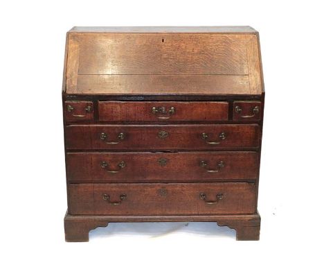An Early 18th Century Oak and Pine-Lined Bureau, the fall front enclosing a simple interior of drawers, with three small and 