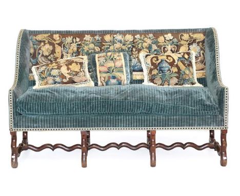 A 17th Century Style Wing-Back Sofa, late 19th/early 20th century, covered in blue striped fabric with central needlework bac