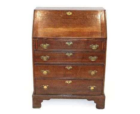 A George II Oak Bureau, 2nd quarter 18th century, the fall enclosing a later fitted interior above four long graduated drawer