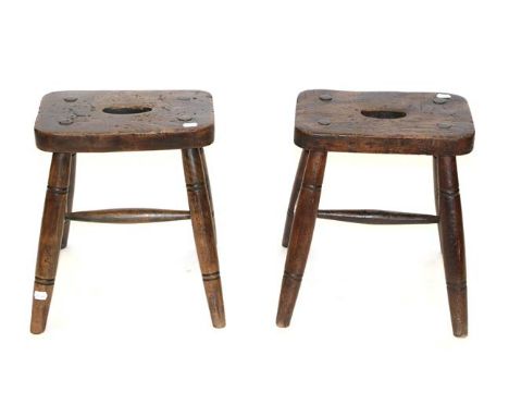 A Pair of Elm-Seated Stools, mid 19th century, of pegged construction, on turned and spindle supports, 38cm by 25cm by 47cm C