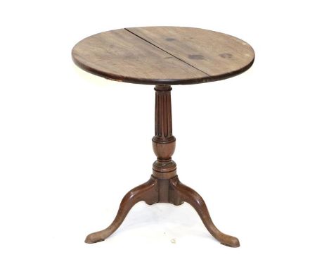 A George III Padouk Wood Tripod Table, 3rd quarter 18th century, the circular two piece pivoting top on a fluted vasiform sup