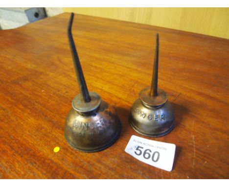  Sale Item:    2 SINGER OIL CANS   Vat Status:   No Vat   Buyers Premium:  This lot is subject to a Buyers Premium of 15% + V