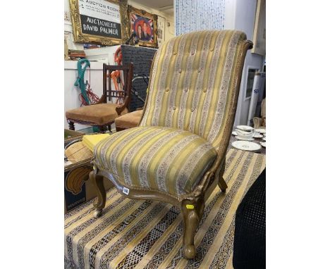 A Victorian nursing chair, button backed on Cabriole legs