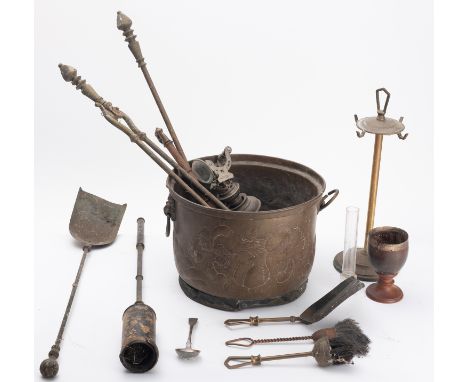 A brass coal bucket and fireside tools. The bucket having floral decoration with a set of tongs, two shovels and a brush etc.