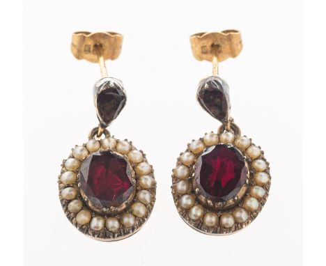 A pair of garnet and pearl drop earrings, each set to the top with a pear-shaped garnet with an oval suspending drop set to t