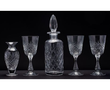 A modern cut glass decanter and wine glasses. Together with two crystal glass vases, boxed.