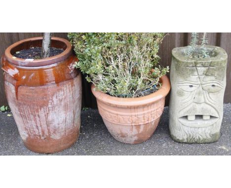 A partially glazed stoneware pippin planter, with moulded handles, 58cm high, a modern stone trough with olive bush and shrub