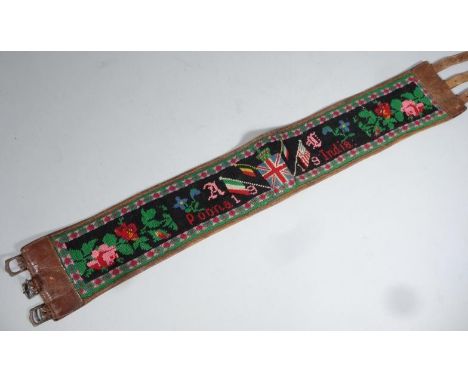 A 1919 leather and knitted Indian Poona (Pune) adjustable belt sash, partially embroidered with flowers, 74cm wide.