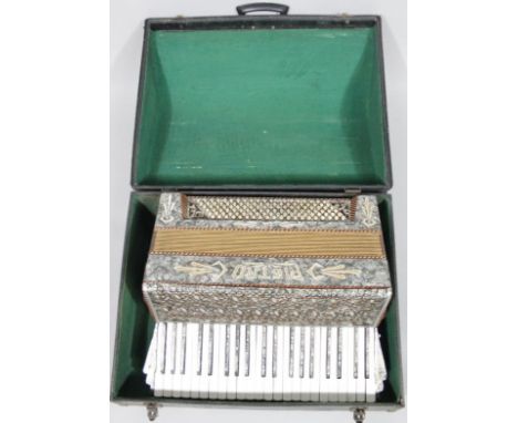 A mid-20thC Petro Art Deco piano accordion, of shaped outline, 53cm wide, in fitted case.