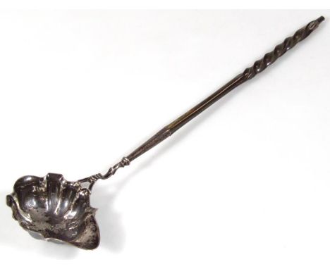 A George II silver punch ladle, with partially turned whale bone handle and part pierced stem, with a compressed shell and li