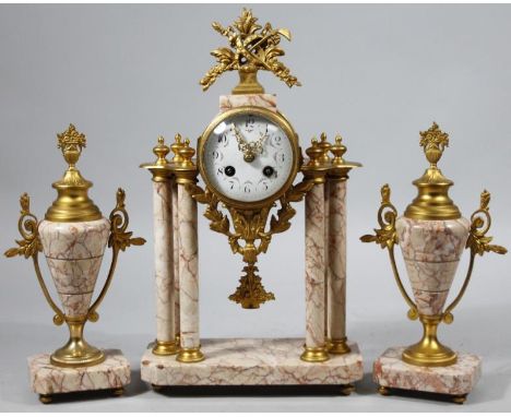 A late 19thC gilt metal and pink marble clock garniture, the enamel dial decorated with floral swags with cylindrical column 