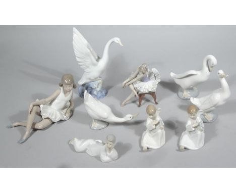 Various Nao, Lladro and other figure groups, to include ballerina in seated pose, marked Lladro beneath, 16cm high, geese, an