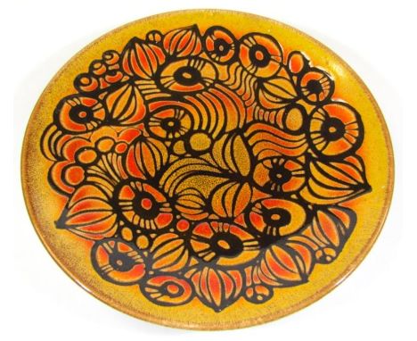 A Poole charger, sgrafitto finished with a floral design on brown ground, 35cm dia.