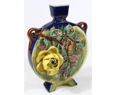 A late 19thC Continental majolica pottery moon flask, raised with moulded flower heads and leaves predominantly in yellow, gr