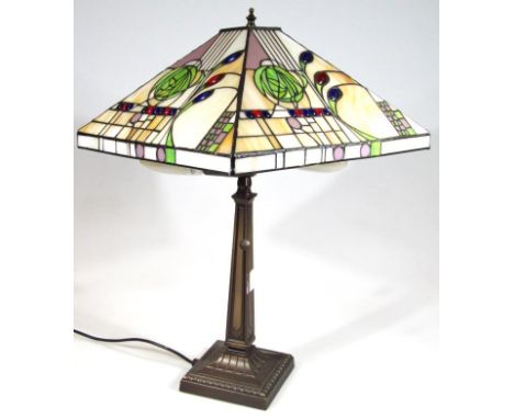 A modern frosted glass Art Nouveau style table lamp, decorated with stylised flowers and beads predominantly in blue, orange,