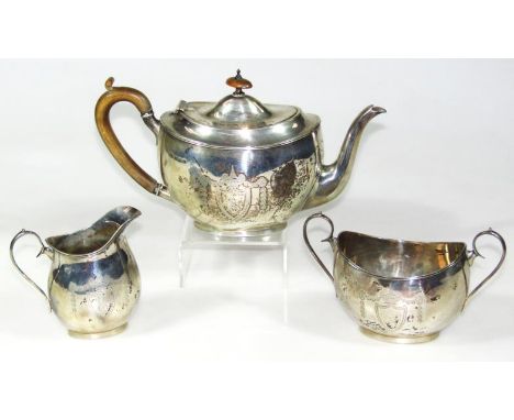 A George V silver three piece tea service, comprising Neo-Classical design tea pot of rounded cape form with wooden thumb scr