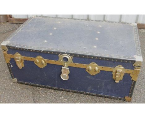 A 20thC cabin style steamer trunk, with an outer bead decoration and brass banding, with heavy locks and fitted interior, 34c