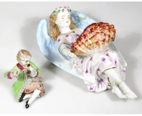 A Continental porcelain angel wall hanging, polychrome decorated, she with arms outstretched holding shell, 9. mark beneath, 