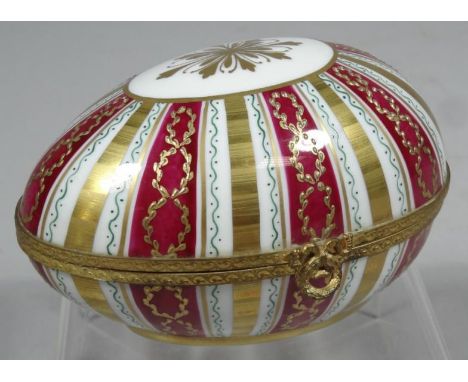 A 20thC La Tallec Parisian enamel style egg shaped casket, decorated with gilt highlights, painted marks beneath, 13cm wide.