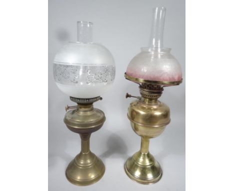 An early 20thC brass oil lamp, with frosted clear and etched glass shade, clear funnel and brass part fluted stand, 55cm high