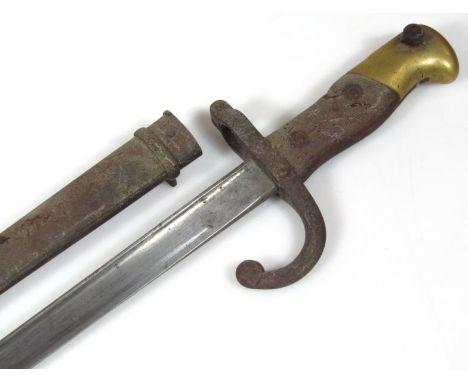 19thC St Etienne bayonet and scabbard, with shaped wooden handle, brass ends etched and signed to the side of the blades, 66c