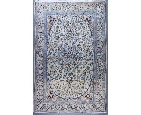 A Nairn Carpet, woven in pastel shades of light and dark blue, and fawn, with a bold central pole medallion, the field filled