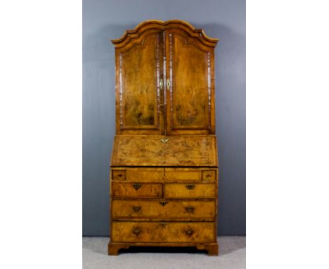 A George II Walnut Bureau Cabinet, the whole veneered in figured walnut and inlaid with herringbone bandings and crossbanded,
