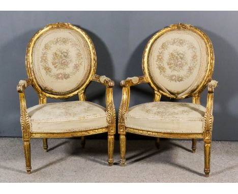A Pair of French Gilt Framed Fauteuil of "Louis XVI" Design, the oval backs with moulded and carved showwood frames, seats, b