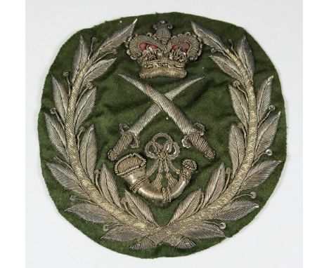 A Rifle Brigade Colour Sergeant's Arm Badge, Circa Early 1800s, worked in silver thread on green ground, with one bugle