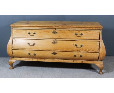 A 19th Century Continental Strip Pine Bombe Commode, fitted three long drawers, on later cabriole legs, 63.5ins wide x 24ins 