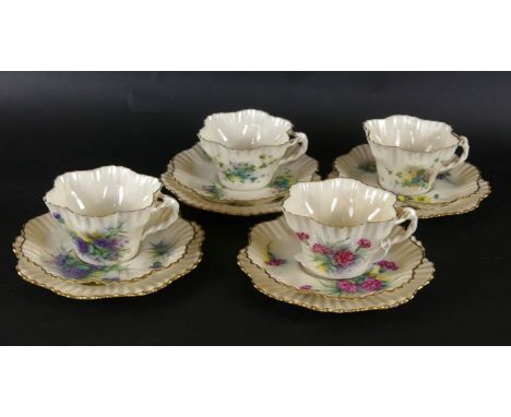 A collection of Belleek floral decorated teawaresComprising six trios plus two extra cup and cake plate, black printed marks 