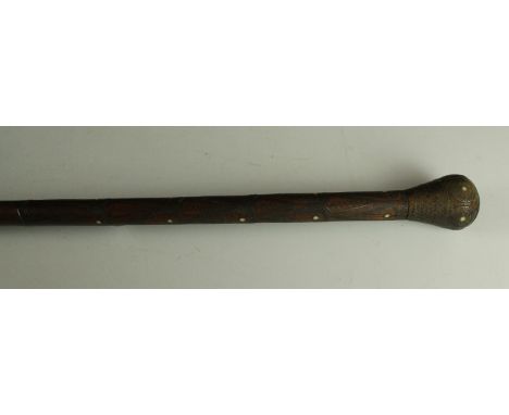 An early 20th Century Eastern walking stickThe top quarter of the stick inlaid with metalwork, length 86cm