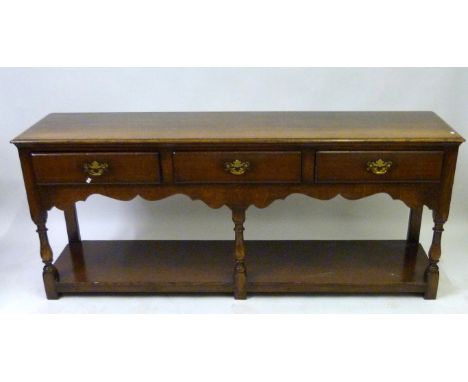 A good quality reproduction oak three drawer dresser baseWith turned legs and pot board shelf, width 183cm.   CONDITION REPOR