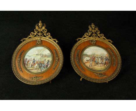 A pair of French portrait miniatures Each depicting battle scenes, one example signed Gerard, each fitted in circular wooden 