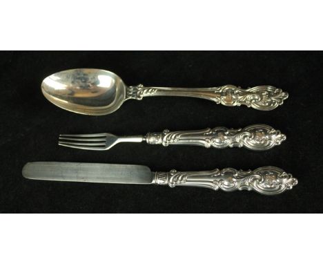 A Victorian silver matched three piece flatware setComprising; dessert spoon, dessert knife and fork, with silver blade and t
