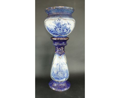 A large Sarreguemines blue and white jardiniere with standDecorated with panels of flowers with gilt highlights, height 97cm.