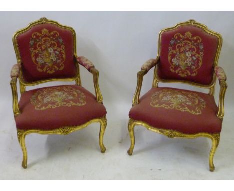 A pair of early 20th Century continental giltwood armchairsWith floral tapestry detail, 64cm wide.   CONDITION REPORT:  91cm 
