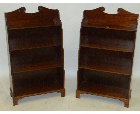 A pair of 20th Century mahogany four shelf bookcasesWith broken arch pediment detail, 61cm wide.