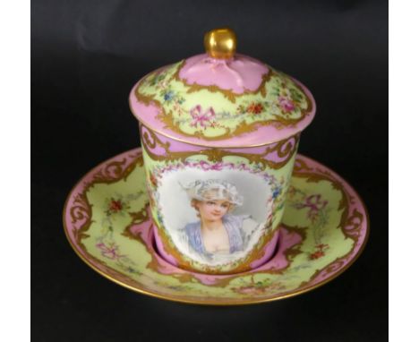 A Sevres porcelain covered chocolate cup and saucerThe cup decorated with a portrait panel depicting a young lady, surrounded