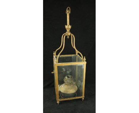 An early 20th Century gilt metal hanging oil lamp holderHaving four clear glass panels with cut star design, height 70cm