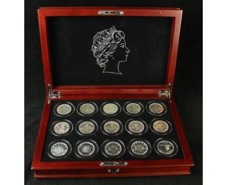 A cased set of fifteen brilliant uncirculated silver dollarsCanadian dollars dating from 1953-1967, each coin housed in a pla