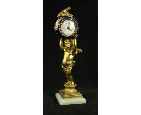 A 19th Century ormolu figural mantel clockModelled in the form of a cherub supporting a spherical ball with applied mounts an