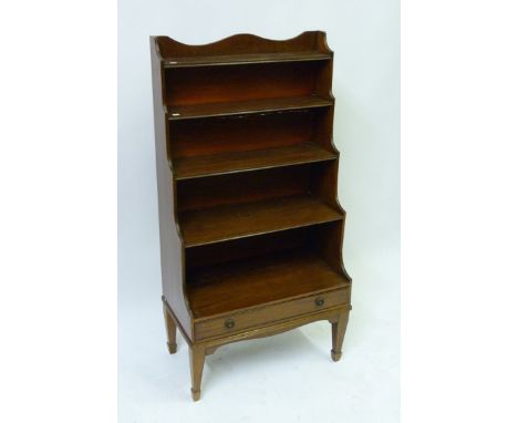 A small 19th Century mahogany five shelf waterfall bookcaseWith full length base drawer, raised on tapering legs with spade f