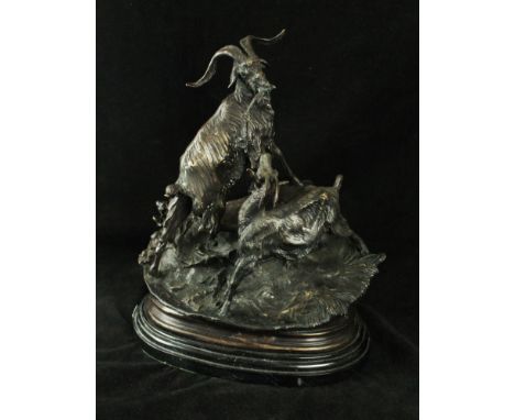A reproduction bronze figure groupDepicting two rams raised on naturalistic plinth base, height 30cm, length 23cm 