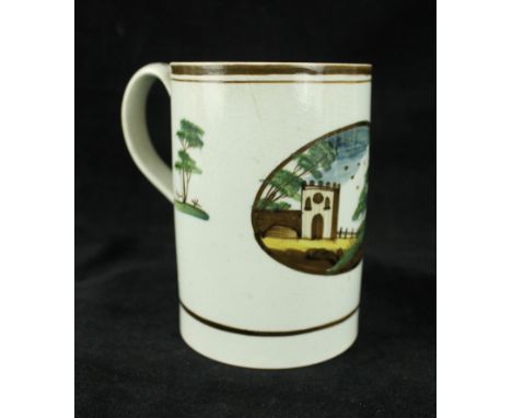 An 18th/early 19th Century Creamware tankardDecorated with a painted panel of a gatehouse, height 12cm.   CONDITION REPORT:  