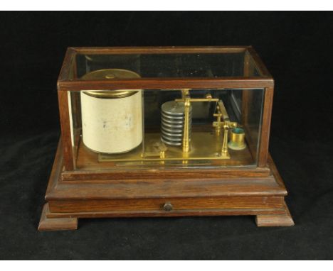 An early 20th Century oak cased barograph Having single base drawer, height 22cm, length 36cm    CONDITION REPORT:  Plaque re