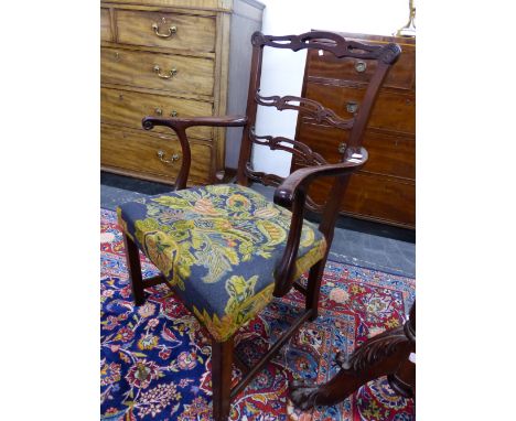 A GEORGE III MAHOGANY TRIPLE PIERCED LADDER BACKED ELBOW CHAIR, THE FLORAL NEEDLE WORKED SEAT ABOVE CANTED SQUARE LEGS