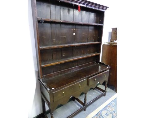 A 19th C. OAK DRESSER, THE ENCLOSED THREE SHELF BACK ON A BASE WITH TWO DRAWERS, A WAVY APRON AND BALUSTER LEGS JOINED BY STR
