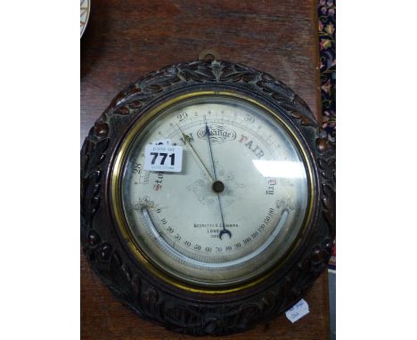 AN OAK FRAMED NEGRETTI AND ZAMBRA ANEROID BAROMETER WITH A MERCURY THERMOMETER.   Dia. 26cms. TOGETHER WITH A MAHOGANY CASED 